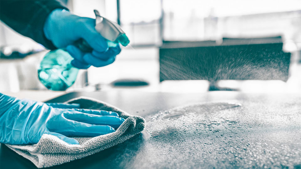 chef safely disinfecting food surface