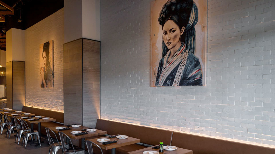 interior shot of tables and asian art in boathouse restaurant in california