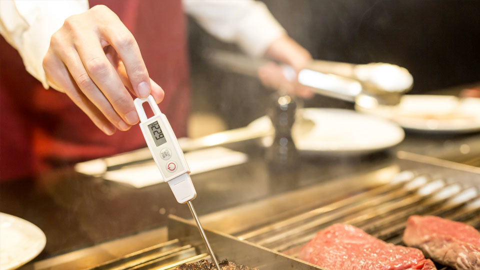 chef using temperature sensor to safely cook meat