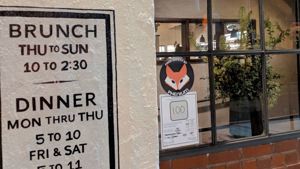 exterior of restaurant with phenium seal of approval for food safety stuck to door